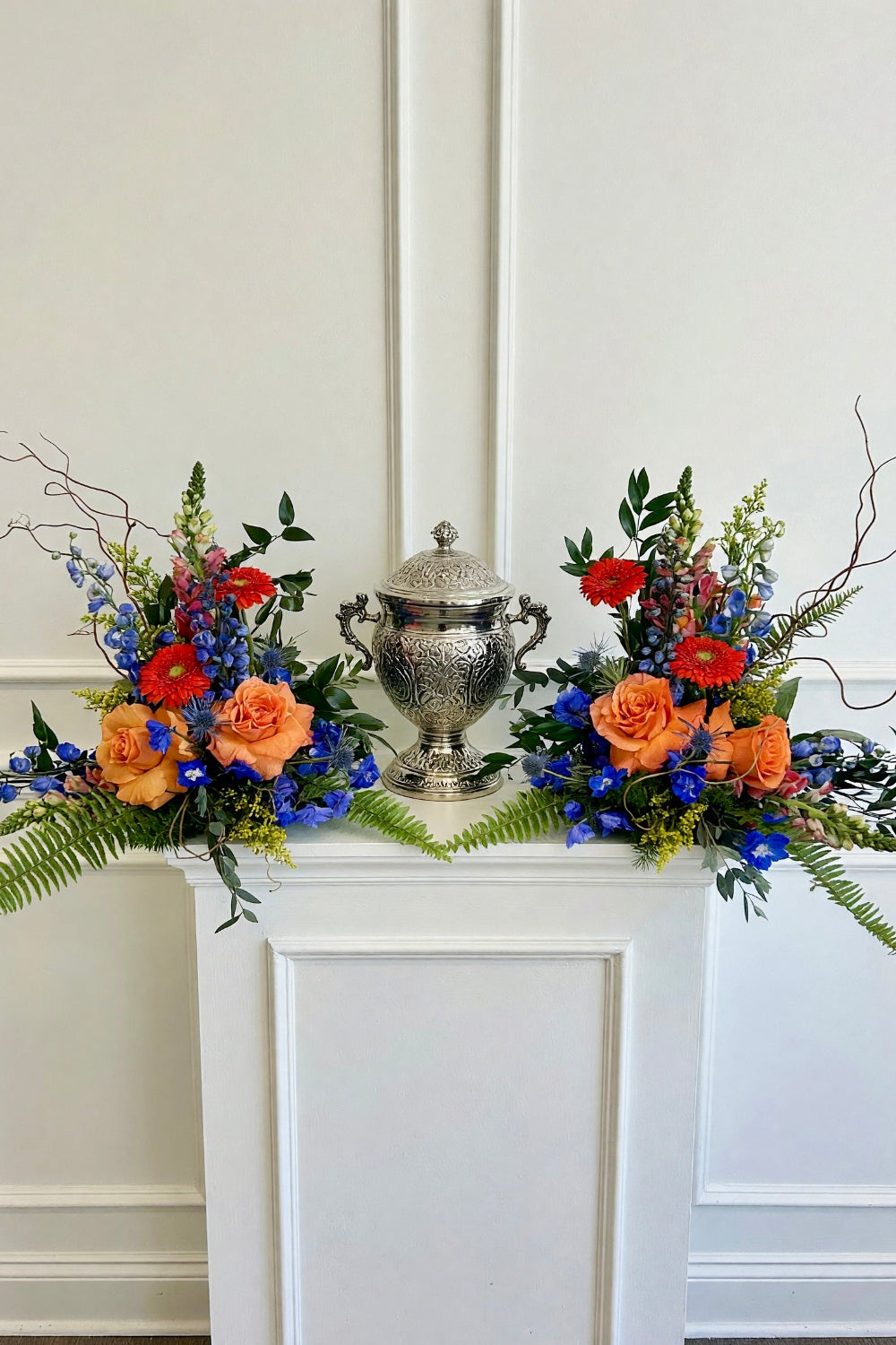colorful masculine flower bouquets framing funeral urn