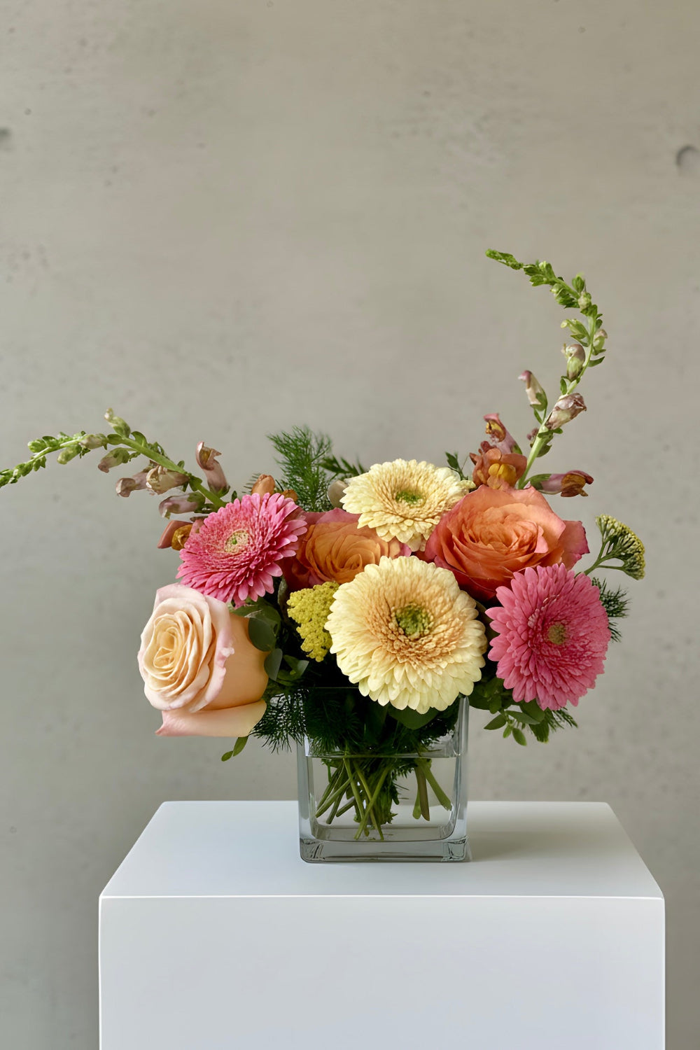 peach and pink flowers designed in a vase for birthdays