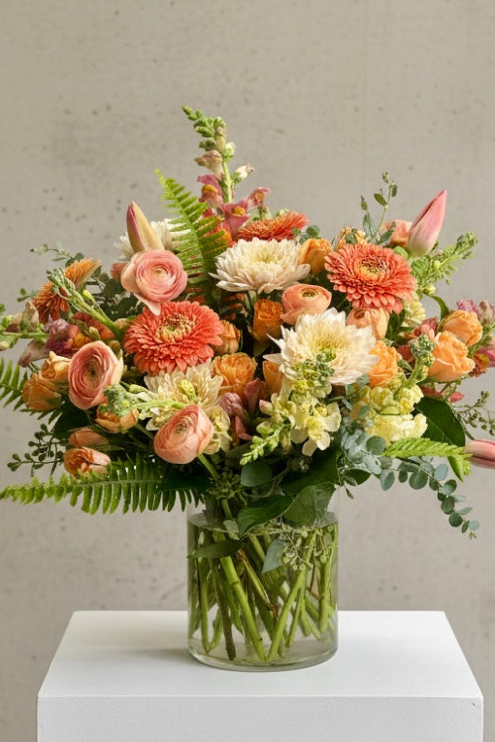 premium peach and pink and yellow flowers designed in a vase