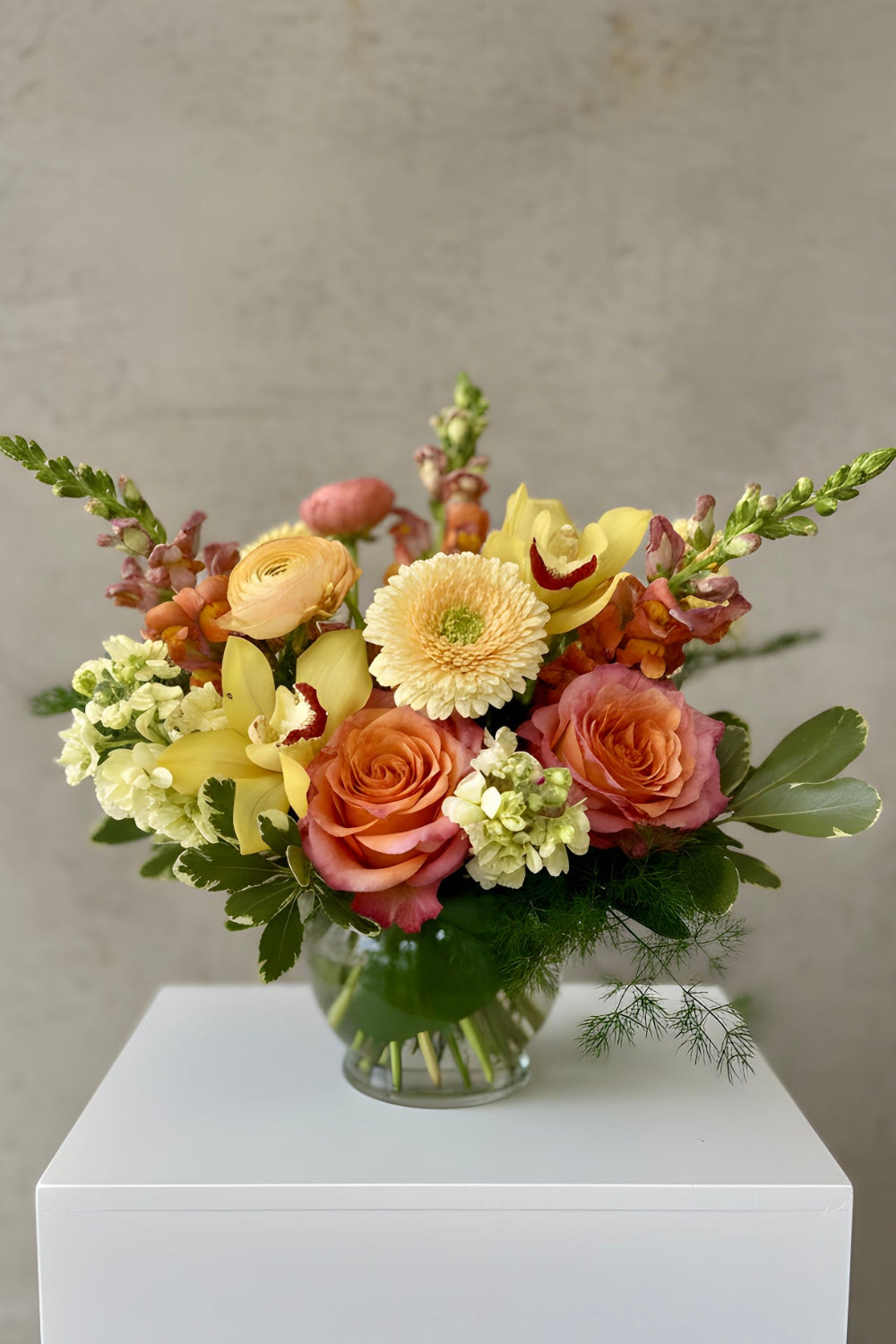 peach, pink and yellow flowers designed in a vase for delivery in Grant NE