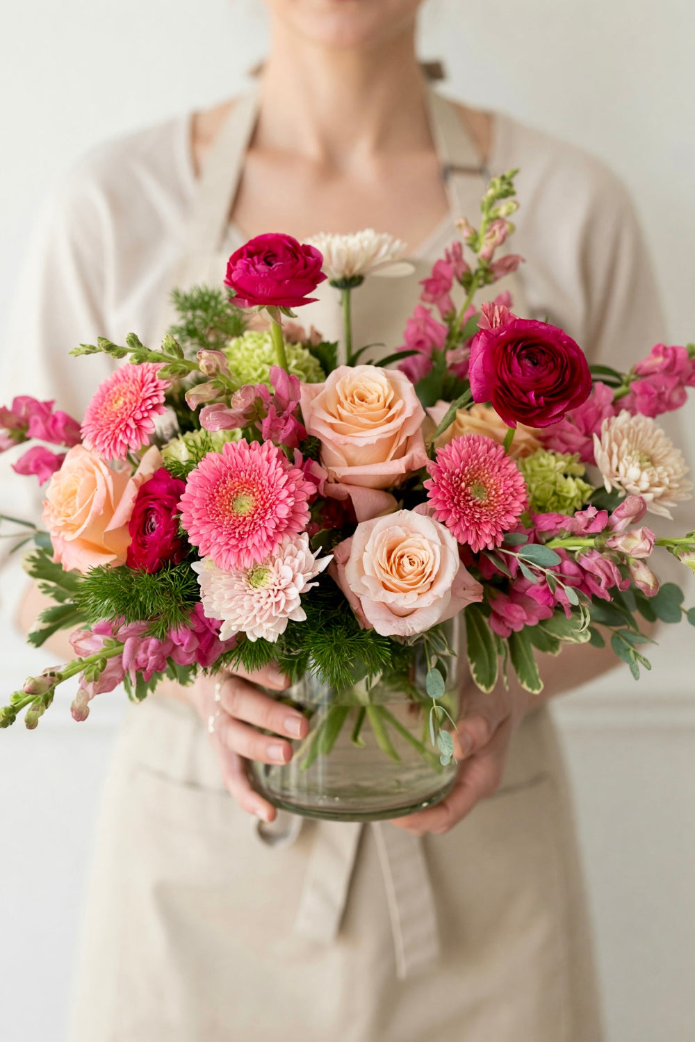 woman holding pink bouquet of flowers for delivery in Grant, Ogallala, and surounding areas.
