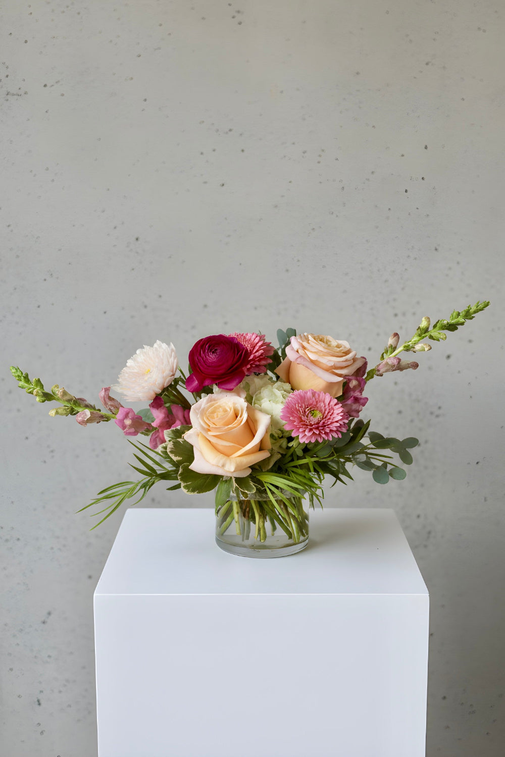 petite bouquet of pink flowers with roses, ranunculus, gerbera daisy