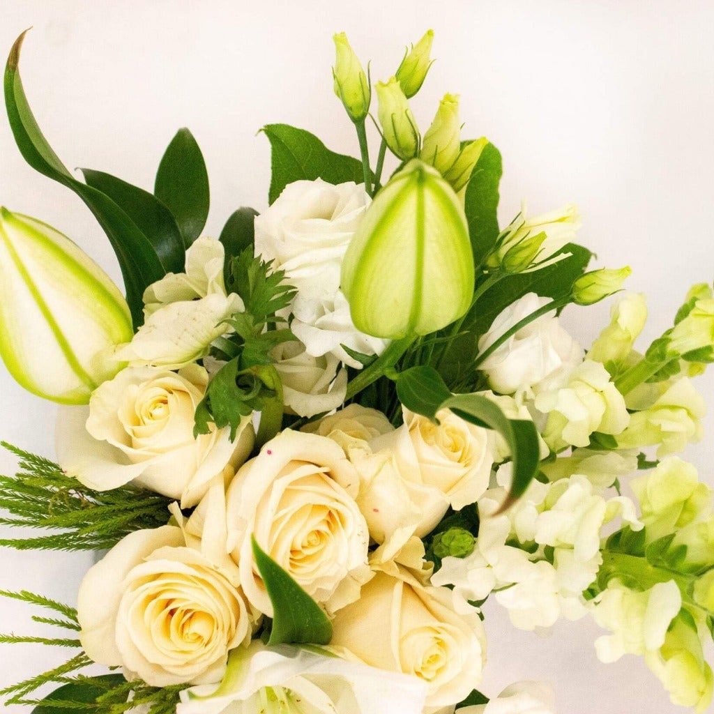roses, lilies, snapdragons all in white