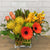 protea, orchids, tulips, gerbera daisies, leaf wrapped vase