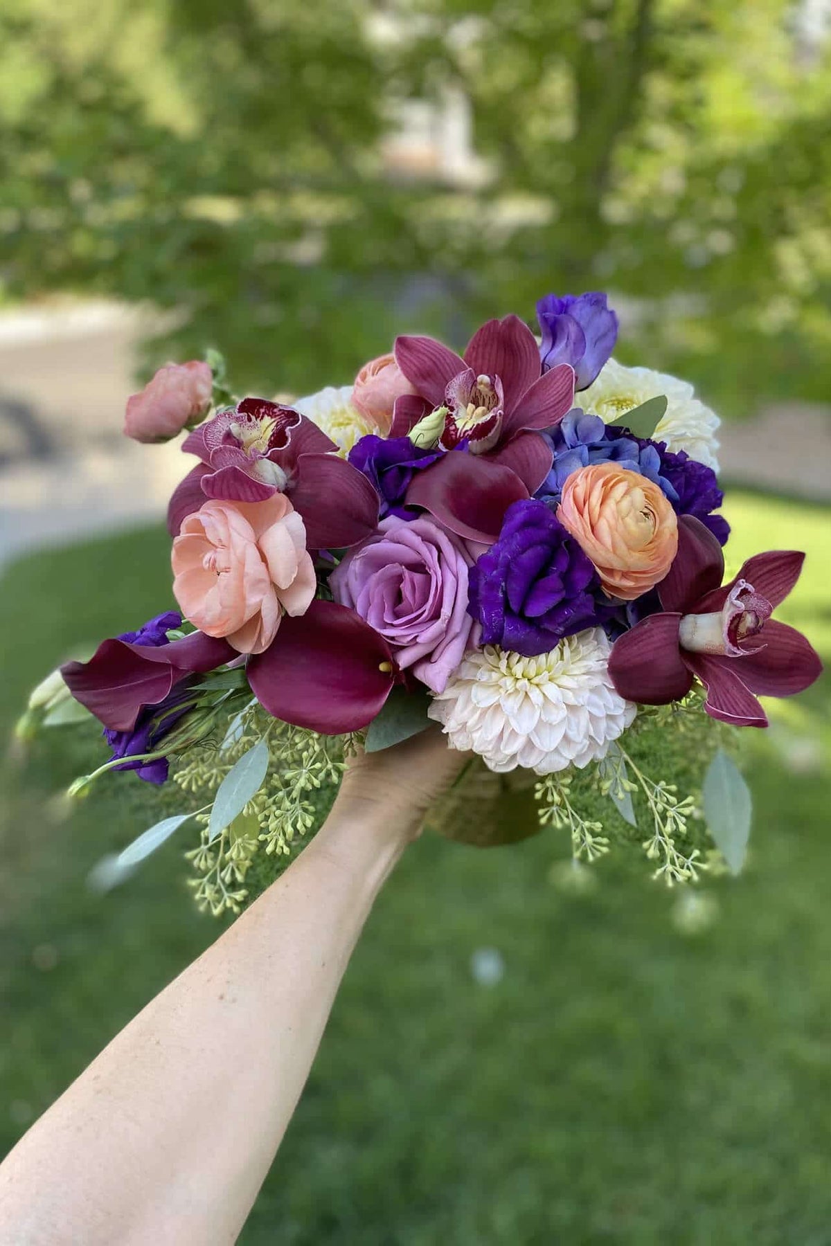roses, orchids, calla lilies in berry tones